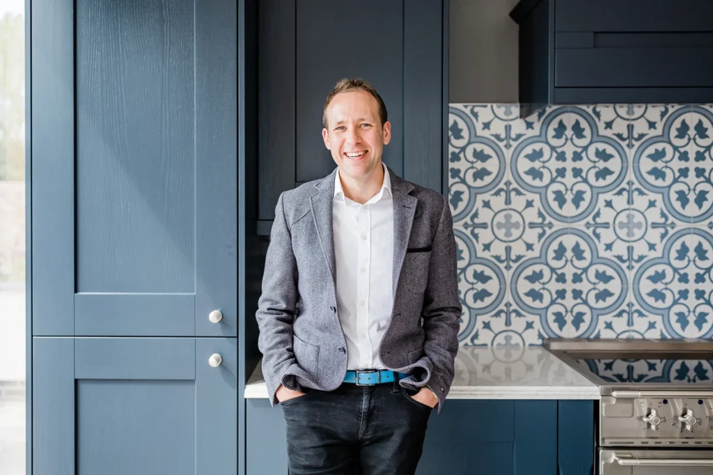 Paul Mitchell standing in a kitchen smiling